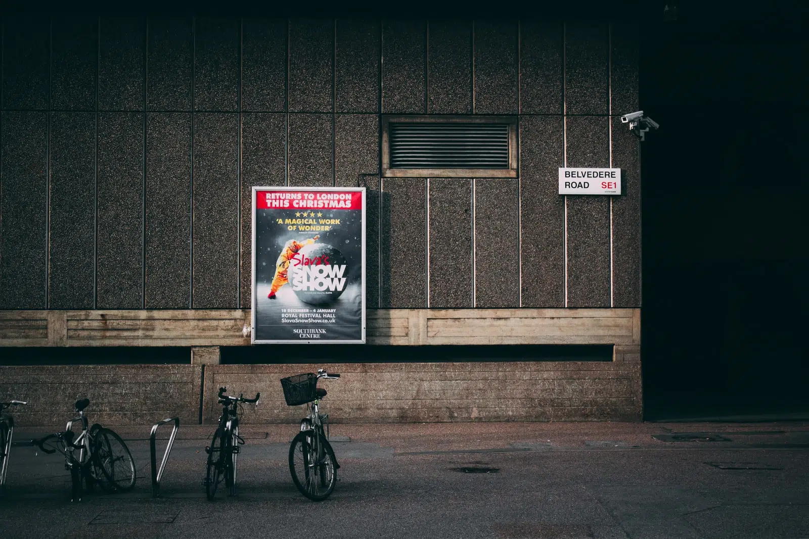 bicycle parked near concrete wall
